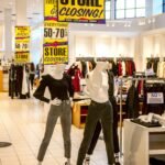 man in black long sleeve shirt and white pants standing beside woman in white long sleeve